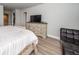 Light and bright main bedroom with ample closet space, wood-look flooring, and neutral walls at 26082 Woven Wicker Bnd, Lutz, FL 33559