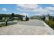 Gated community entrance with lush landscaping and paved road, enhancing curb appeal at 26082 Woven Wicker Bnd, Lutz, FL 33559