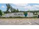 Elegant community entrance sign for Volanti with stone accents and manicured landscaping at 26082 Woven Wicker Bnd, Lutz, FL 33559