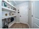 Entry hall boasts floating shelves and wood-look floors at 26082 Woven Wicker Bnd, Lutz, FL 33559