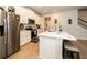 The kitchen is fully equipped with stainless steel appliances, a breakfast bar, and white cabinets at 26082 Woven Wicker Bnd, Lutz, FL 33559
