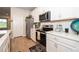 Bright kitchen featuring white cabinets, stainless steel appliances, and light countertops at 26082 Woven Wicker Bnd, Lutz, FL 33559