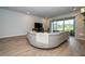 Open-concept living area features wood floors and large glass doors at 26082 Woven Wicker Bnd, Lutz, FL 33559
