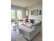 Living room showcases a view of the pond and patio with glass sliding doors at 26082 Woven Wicker Bnd, Lutz, FL 33559