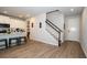 Open-concept living area and staircase with wood floors at 26082 Woven Wicker Bnd, Lutz, FL 33559