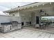 Relax in the outdoor kitchen featuring a built-in grill, sink, and seating area at 26082 Woven Wicker Bnd, Lutz, FL 33559