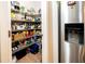Well-stocked walk-in pantry offers ample storage space with shelving at 26082 Woven Wicker Bnd, Lutz, FL 33559