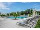 Resort-style community pool featuring comfortable lounge chairs and shaded seating areas for relaxation at 26082 Woven Wicker Bnd, Lutz, FL 33559
