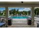 A serene view of the community pool area with plenty of lounge chairs and shade at 26082 Woven Wicker Bnd, Lutz, FL 33559