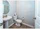 Elegant powder room with pedestal sink and modern fixtures at 26082 Woven Wicker Bnd, Lutz, FL 33559