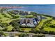Expansive aerial view showcases condo buildings nestled among golf courses, ponds, and waterfront scenery at 2621 Cove Cay Dr # 309, Clearwater, FL 33760