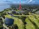 Panoramic aerial view displays condo buildings alongside golf courses, ponds, and picturesque green expanses at 2621 Cove Cay Dr # 309, Clearwater, FL 33760