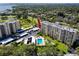 High aerial view reveals condo buildings near golf courses, swimming pool, parking, and verdant landscapes at 2621 Cove Cay Dr # 309, Clearwater, FL 33760
