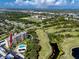 Enjoy a stunning aerial view of this golf course community with a pool, lush greenery, and scenic ponds at 2621 Cove Cay Dr # 309, Clearwater, FL 33760