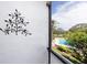 Screened balcony showing pool view, landscaping, and decorative wall art at 2621 Cove Cay Dr # 309, Clearwater, FL 33760