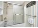 Bright bathroom featuring a shower-tub combo, sliding glass door, and a cheery sign at 2621 Cove Cay Dr # 309, Clearwater, FL 33760