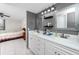Bathroom features a double vanity with modern fixtures and gray accent wall at 2621 Cove Cay Dr # 309, Clearwater, FL 33760