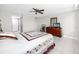 Bedroom with white tile flooring, ceiling fan, and dresser with mirror at 2621 Cove Cay Dr # 309, Clearwater, FL 33760