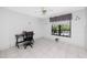 Bedroom featuring a ceiling fan, large window and tile floors at 2621 Cove Cay Dr # 309, Clearwater, FL 33760