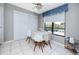 Bright breakfast nook with tile flooring, cozy table setting, and natural light from a large window at 2621 Cove Cay Dr # 309, Clearwater, FL 33760