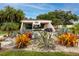 Cove Cay entrance with lush landscaping and a gate house at 2621 Cove Cay Dr # 309, Clearwater, FL 33760