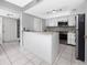 Open kitchen featuring bright cabinets, stainless steel appliances, and a functional breakfast bar at 2621 Cove Cay Dr # 309, Clearwater, FL 33760