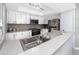 The cozy kitchen features bright white cabinets and modern stainless steel appliances at 2621 Cove Cay Dr # 309, Clearwater, FL 33760