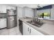 This kitchen features white cabinets, stainless steel appliances, a sink and tile floors at 2621 Cove Cay Dr # 309, Clearwater, FL 33760