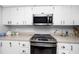 Well-maintained kitchen with stainless steel appliances, white cabinets, and functional design at 2621 Cove Cay Dr # 309, Clearwater, FL 33760
