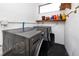 Laundry room with new front-load washer and dryer and utility shelving at 2621 Cove Cay Dr # 309, Clearwater, FL 33760