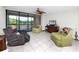 Spacious living room with cozy seating, a ceiling fan, and access to a balcony with scenic views at 2621 Cove Cay Dr # 309, Clearwater, FL 33760