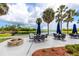 Outdoor seating area with tables, chairs, and views of the lush green surroundings at 2621 Cove Cay Dr # 309, Clearwater, FL 33760