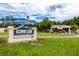 Cove Cay sign at the entrance to the golfing community with mature landscaping at 2621 Cove Cay Dr # 309, Clearwater, FL 33760