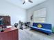 Bedroom/Office featuring a comfy futon and a well-lit work space at 2798 Hilliard Dr, Wesley Chapel, FL 33543