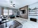Cozy living room with a modern media center, comfortable leather seating, and a stylish area rug at 2798 Hilliard Dr, Wesley Chapel, FL 33543