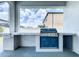 Built in outdoor kitchen featuring a stainless steel gas grill at 2798 Hilliard Dr, Wesley Chapel, FL 33543