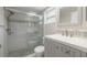 Updated bathroom featuring a glass-enclosed shower, mosaic tile accents, and modern vanity at 310 Arbor E Dr, Palm Harbor, FL 34683