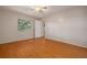 Bright bedroom with hardwood floors, neutral walls, and a window at 310 Arbor E Dr, Palm Harbor, FL 34683