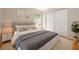 Nicely staged bedroom with a large bed, rug and double door closet at 310 Arbor E Dr, Palm Harbor, FL 34683
