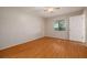 Cozy bedroom with hardwood floors, neutral walls, and a window for natural light at 310 Arbor E Dr, Palm Harbor, FL 34683