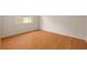 Empty room showcasing wood floors and a bright window, ready for personal customization at 310 Arbor E Dr, Palm Harbor, FL 34683