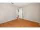 Empty bedroom featuring hardwood floors, neutral walls and a door to the hallway at 310 Arbor E Dr, Palm Harbor, FL 34683