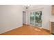 Hardwood floors and a sliding door in the dining area create a bright, inviting space at 310 Arbor E Dr, Palm Harbor, FL 34683