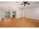 Dining space with hardwood floors, a ceiling fan, and stainless steel appliances at 310 Arbor E Dr, Palm Harbor, FL 34683