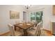 Cozy dining area with seating for six and a sliding door to the outside at 310 Arbor E Dr, Palm Harbor, FL 34683