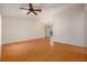 Open-concept living room with vaulted ceiling, ceiling fan and hardwood floors at 310 Arbor E Dr, Palm Harbor, FL 34683