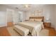 Comfortable main bedroom with hardwood floors, ceiling fan and ensuite bathroom at 310 Arbor E Dr, Palm Harbor, FL 34683