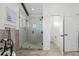 Bathroom featuring a glass-enclosed shower with dual shower heads, pebble floor, and stylish vanity area at 311 12Th N Ave, St Petersburg, FL 33701