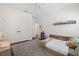 Well-lit bedroom with neutral carpet, a platform bed, and a shelf displaying decorative toys at 311 12Th N Ave, St Petersburg, FL 33701