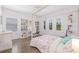 Bedroom with neutral walls, hardwood flooring, and natural light from shuttered windows at 311 12Th N Ave, St Petersburg, FL 33701